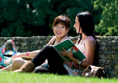Female students sitting outside on Frenchay Campus