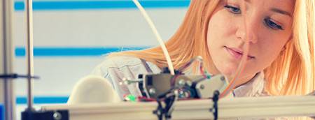 Female using 3D printer Female using 3D printer