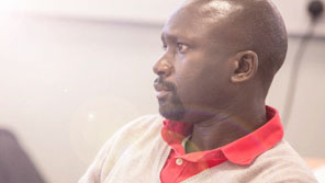 A male law student listening in a tutorial