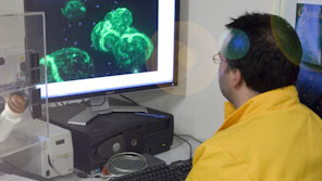 A male student using imaging equipment in a lab
