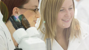 Two female students working in a science lab