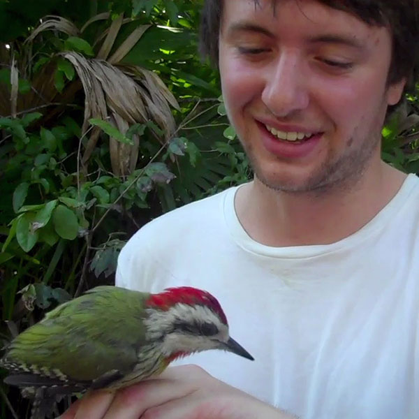 Environmental Science student handles bird on Cuban fieldtrip