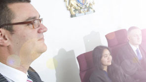 Law students taking part in a simulated trial in a mock courtroom