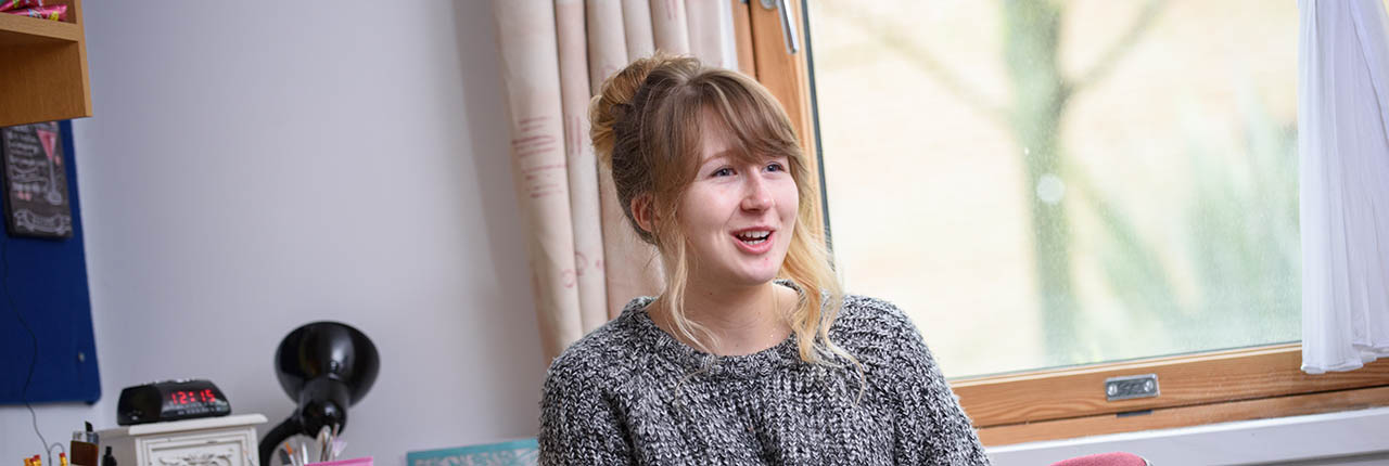 Student sitting in her study bedroom