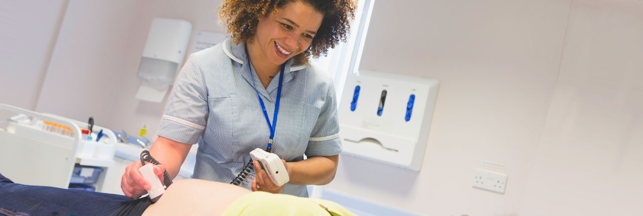Midwife giving expectant mother an ultrasound scan