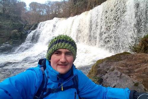 alumni nick in front of a waterfall alumni nick in front of a waterfall