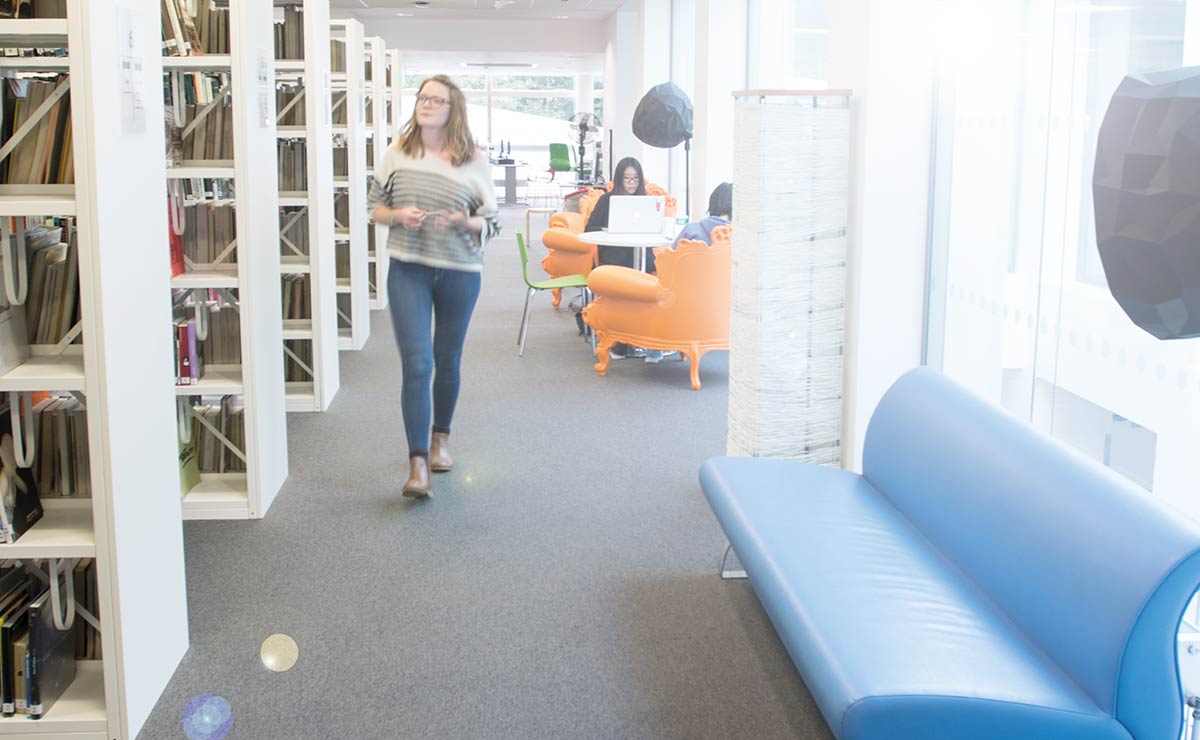 Female students walking through the library